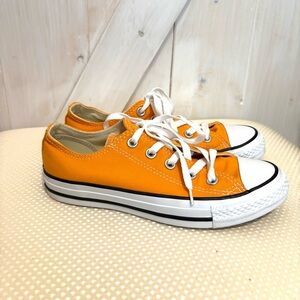 Converse Chuck Taylor All Star OX low-top sneakers in a Orange Ray color.